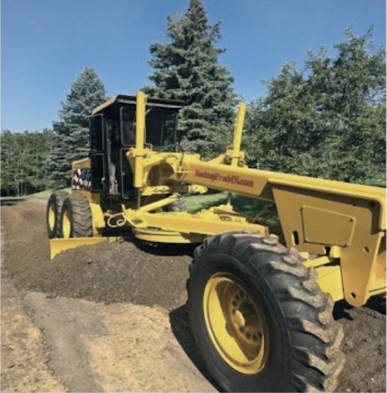 The grader parked on fresh base ready to cut.