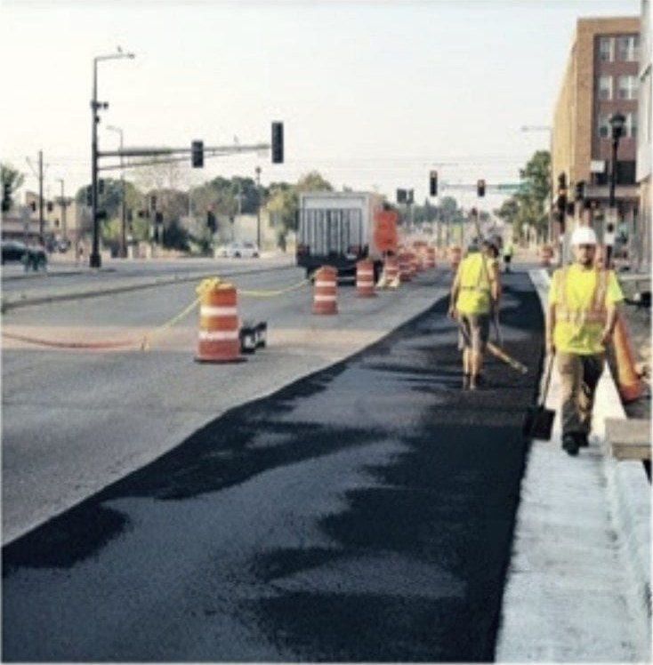 A street job under way with the crew out and the lane coned off.